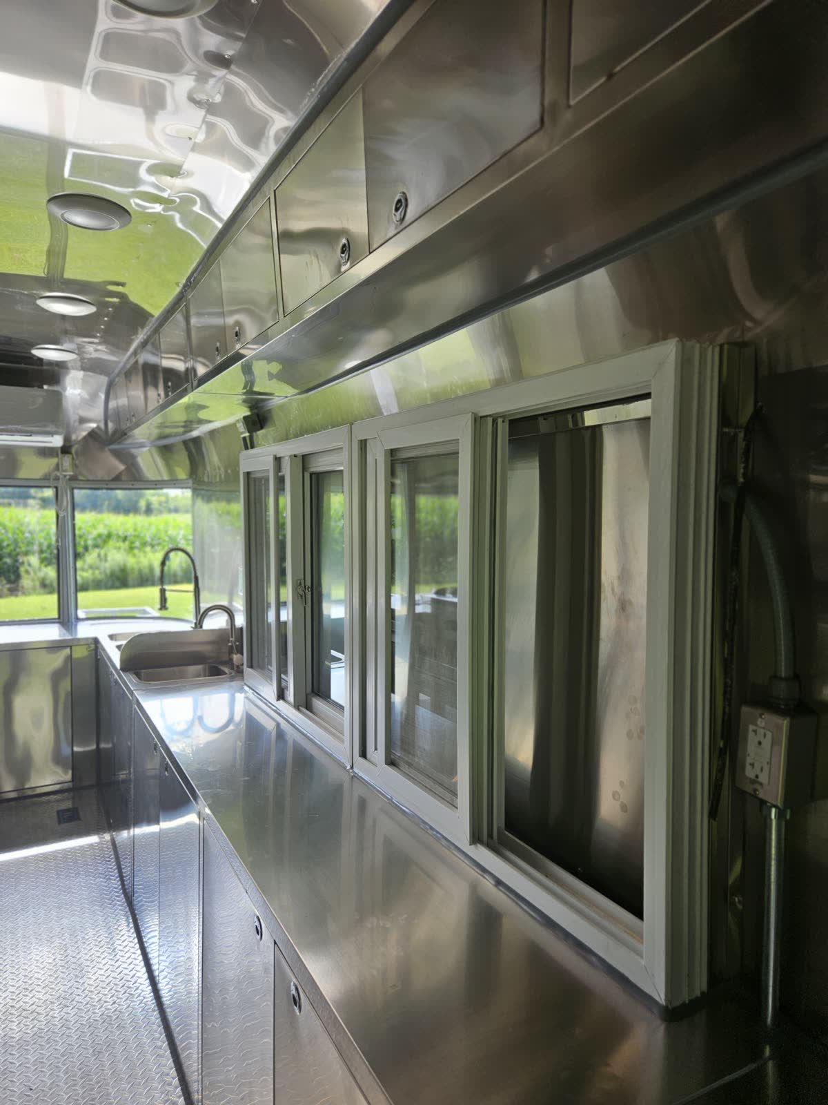 Full-length stainless serving counter with sliding windows